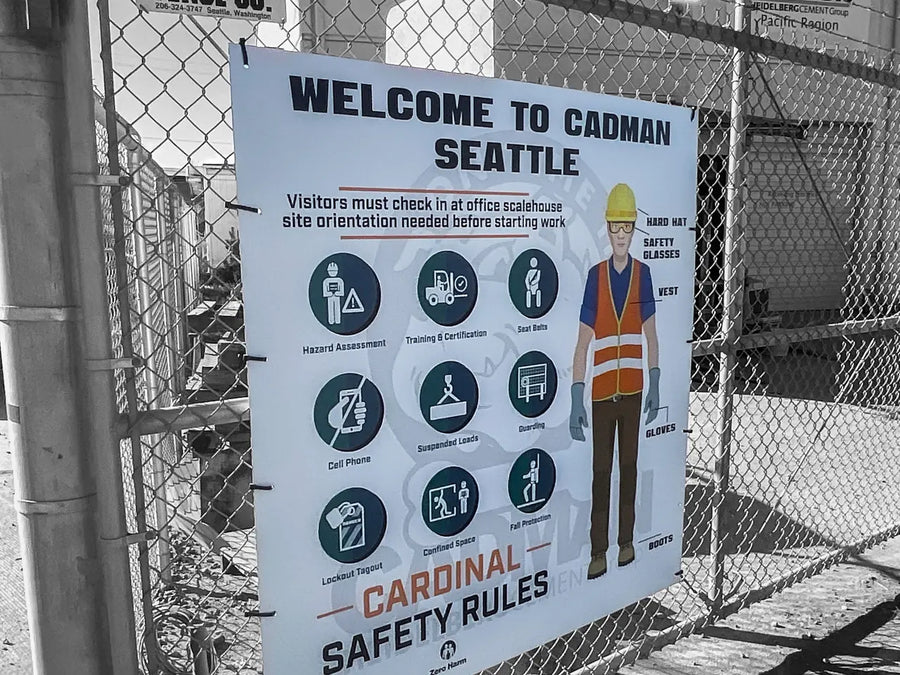 Welcome to Cadman Seattle Cardinal Safety Rules sign on a chain-link fence at the Cadman site in Seattle