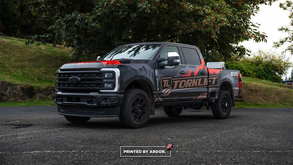 Black TorkLift Ford F-350 pickup truck with a full printed vinyl wrap by Ardor Printing