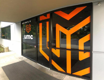 UMC building entrance with large cut vinyl logo window graphics, view 3 by Ardor Printing