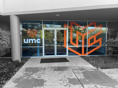 UMC building entrance with large cut vinyl logo window graphics, view 5 by Ardor Printing