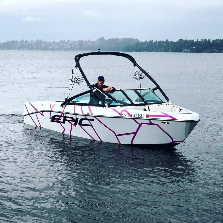 White and purple wake boat wrap on the water