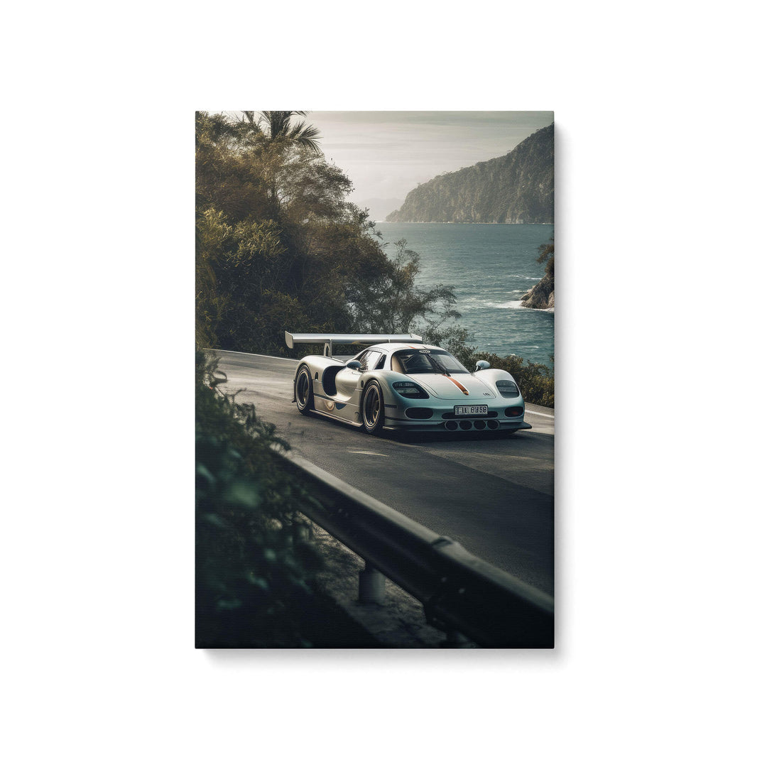 Silver Porsche 911 GT1 Strassenversion cruising through forest with ocean in backdrop on canvas print.